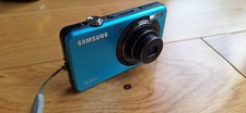 Samsung ST45 Digital Camera, plus charger, working order but battery door Broken