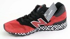 Red and black New Balance 1300 sneaker with white laces, silver tags, and black-and-white checkered sole, size 9.