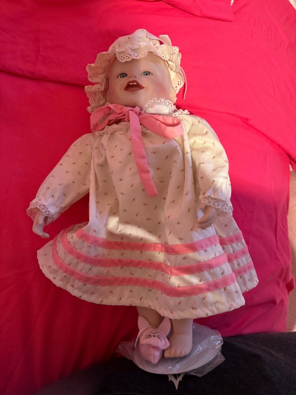 vintage porcelain doll. Baby with pink and white dress