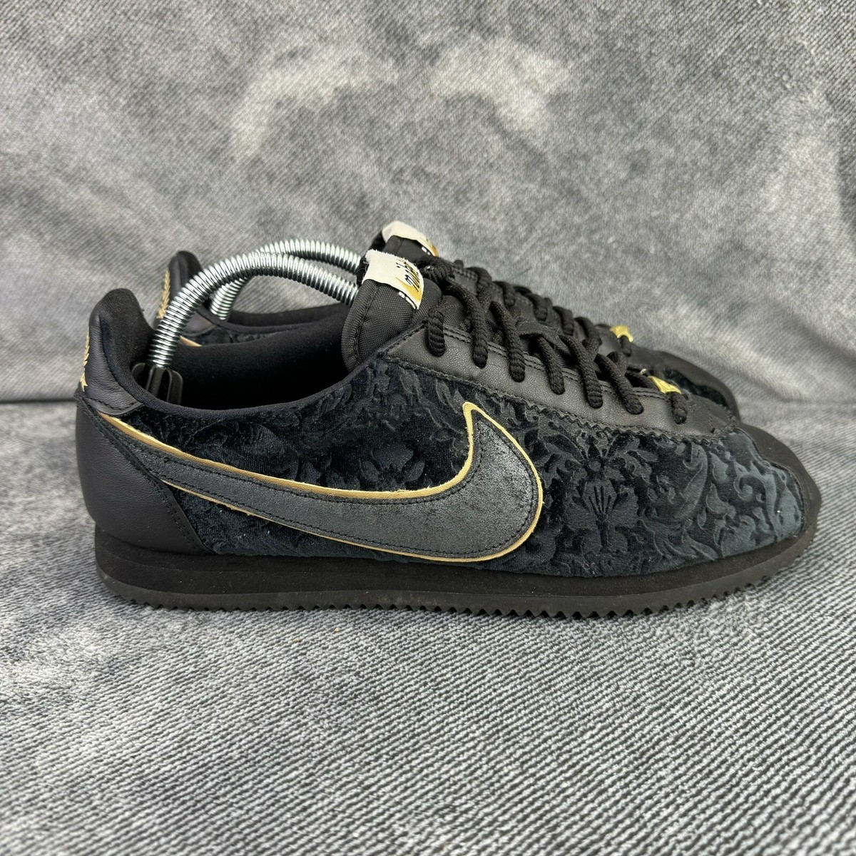 nike black and gold cortez trainers
