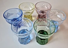 SIX ANTIQUE COLORED AJKA CRYSTAL CORDIAL GLASSES, COLLECTOR PIECES