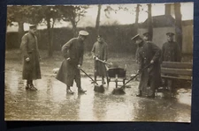 sweeping up a rainy mess group of soldiers with pushbrooms rppc postcard