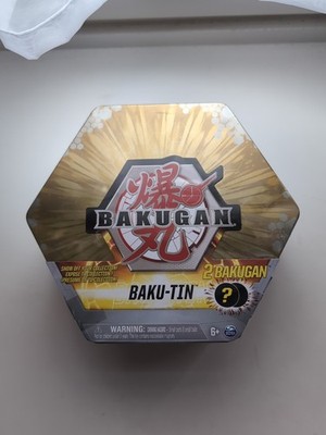 BAKUGAN Baku-Tin, Metall-Aufbewahrungsbox Gold mit 2 Überraschungs Bällen Neu