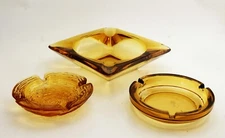Set of Three Mid Century Amber Glass Ashtrays Ancor Hocking Etc.