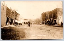 Dundee New York~Horse & Buggy Trots Down Dirt Main St Between Shops~RPPC 1910
