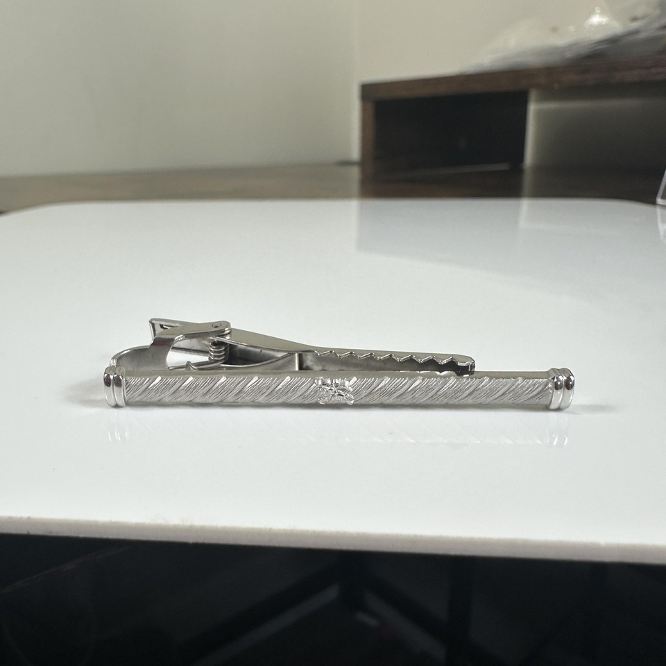 A vintage Burberrys logo tie bar — pre-logo-refresh Burberry with real provenance, the kind of quiet-luxury accessory that seasoned dressers recognize instantly.