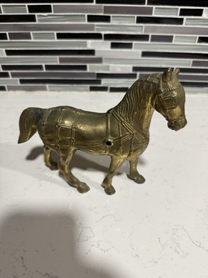 Vintage Gold Colored Cast Iron Horse. Has holes for a wagon attachmen. 