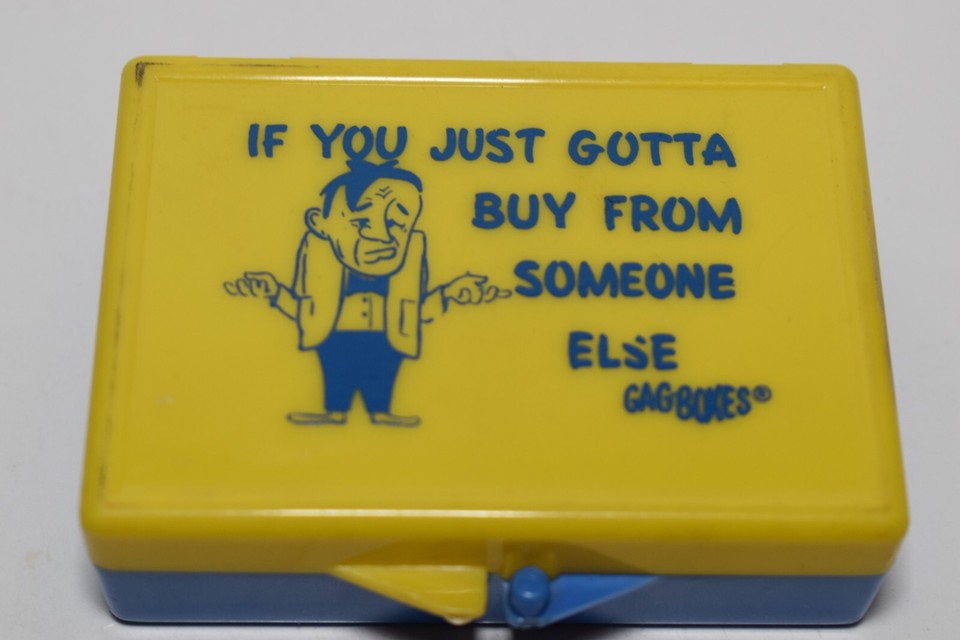 Vintage novelty gag boxes designed to make someone feel guilty for shopping elsewhere — a hilariously passive-aggressive relic of old-school retail culture.