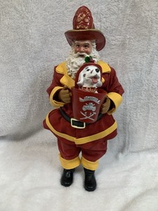 Merry Brite Fire fighter Santa Claus Figurine holding a dalmation dog in bucket