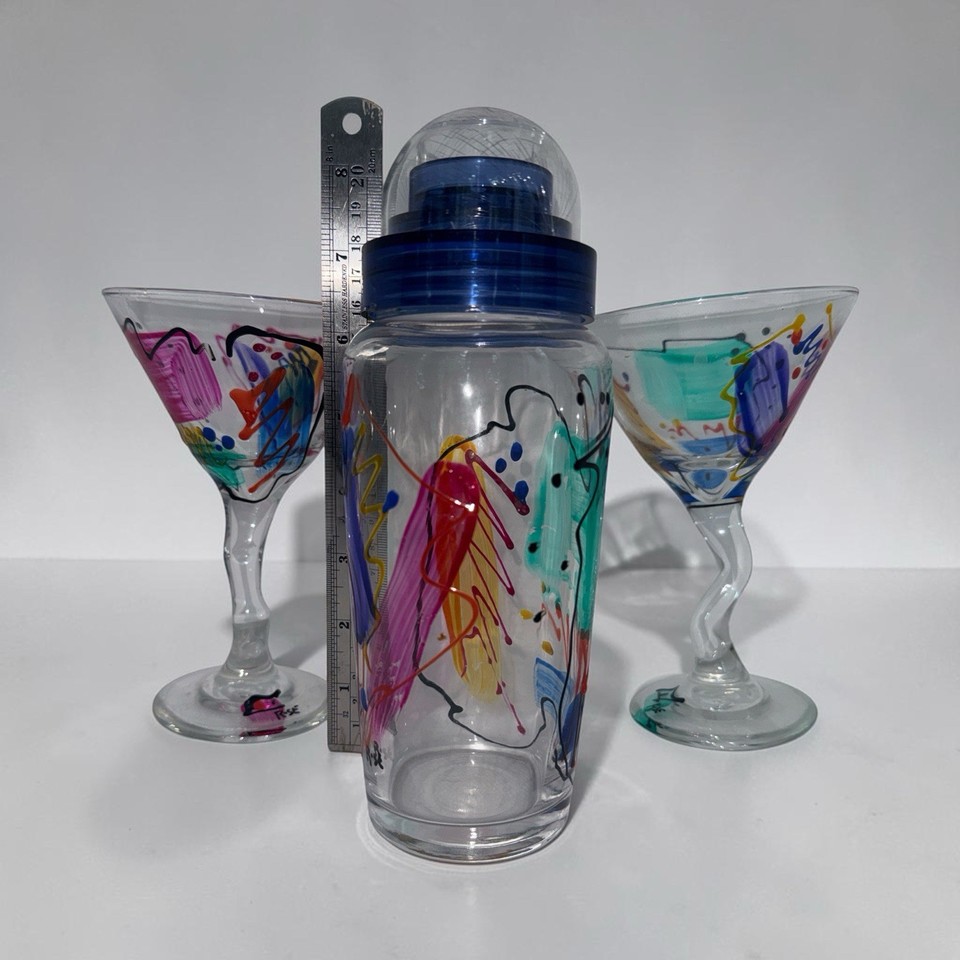 A signed, hand-painted abstract art cocktail shaker + martini glasses set — essentially wearable art for your bar cart.