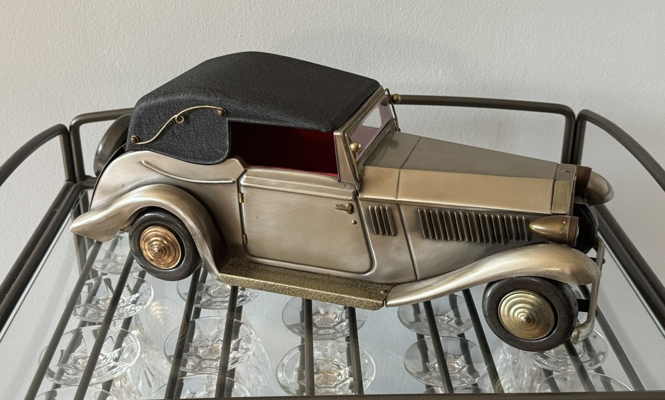 A vintage Rolls Royce convertible decanter that plays music AND comes with 4 glasses — peak 1970s whiskey bar flex.