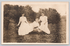 Postcard RPPC Woman Reclining on Bench w Two Women White Dresses Misprint Back