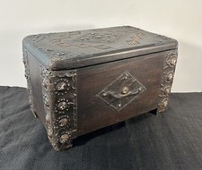 Vintage wooden chest with carvings upholsted with iron
