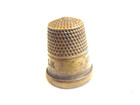 older brass colored thimble captioned "Her Majesty's Thimble England" — photo 6