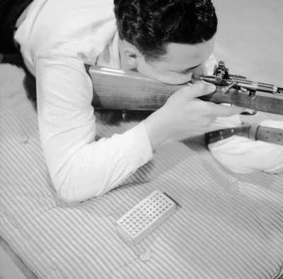 An American teenager learning how to handle guns properly 1950s OLD PHOTO