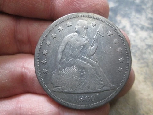 1860 O US SEATED LIBERTY SILVER DOLLAR IN VERY FINE CONDITION DENTED