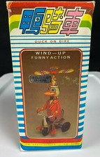 VINTAGE WIND UP FUNNY ACTION DUCK ON A BIKE
