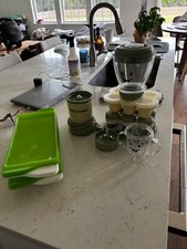 Open but not used Green baby bullet blender with all pieces