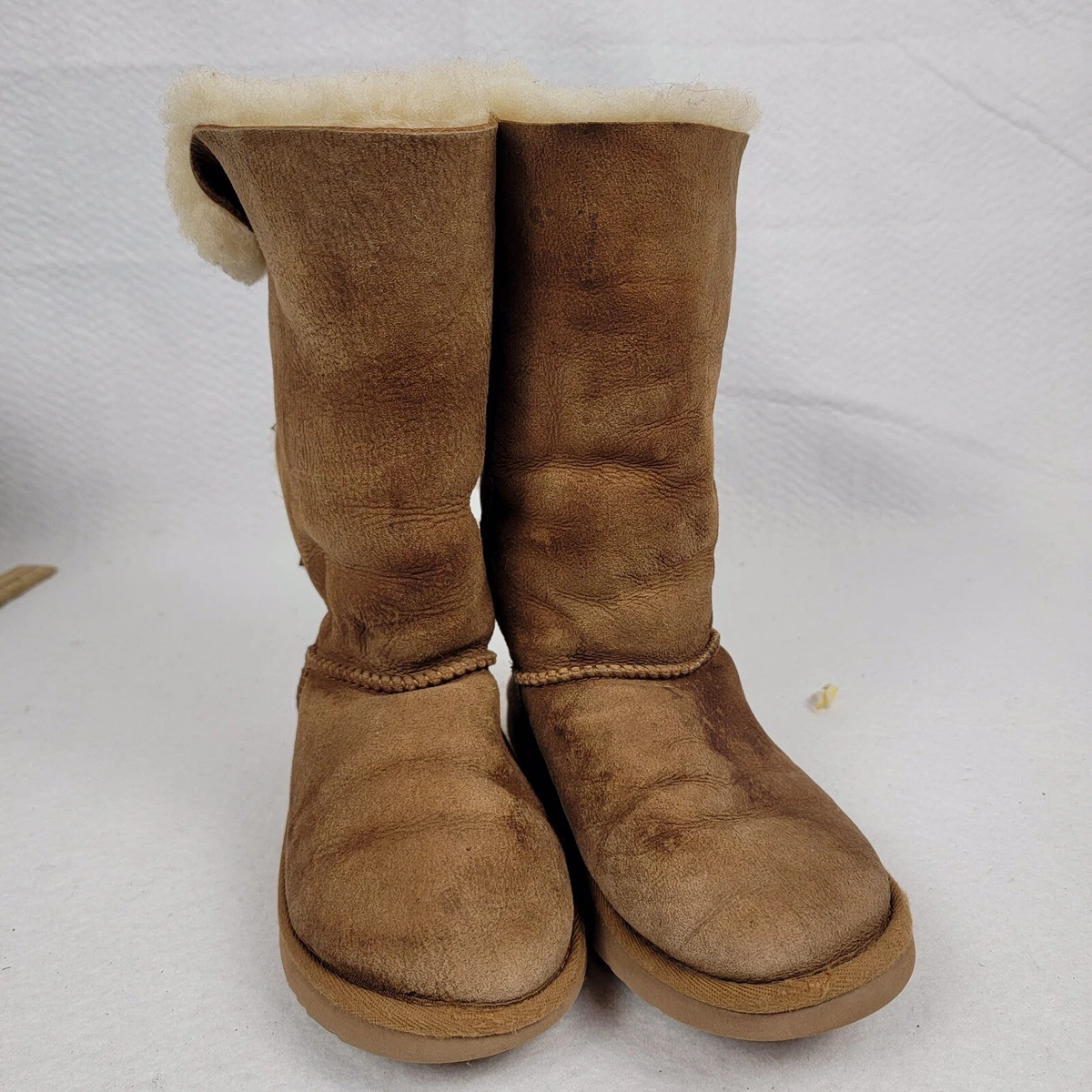 Tan uggs with shop bows on the back