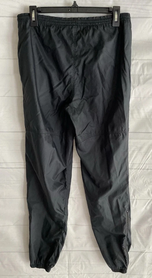 Pantalones de chándal Nike para hombre pequeños de nailon cortavientos con cremallera en el tobillo Swoosh bordados años 90 Foto 2 de 4