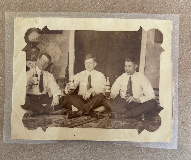 1910s Sepia Toned Photo of 3 Men Drinking from Bottles, Holding Cigars
