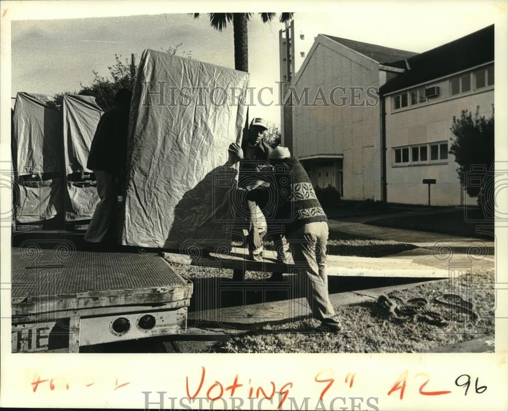 1979 press photo workmen distribute voting machines before an election