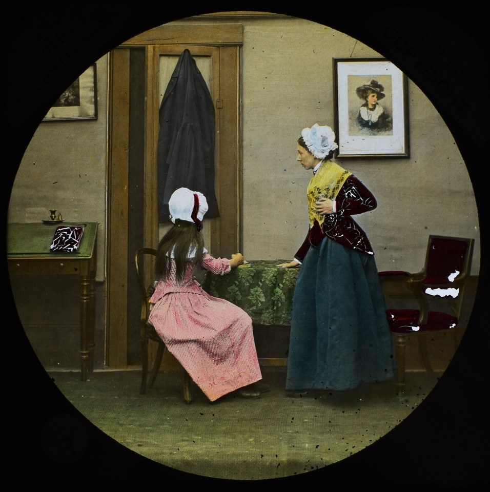 An 1884 magic lantern slide of a Charles Dickens scene — a tangible, glowing slice of Victorian storytelling technology you can actually display.
