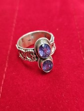 silver ring features two faceted amethyst gemstones in a vertical setting