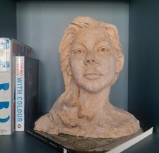 A 20th century pottery head shoulders portrait bust of a young woman 33cm tall