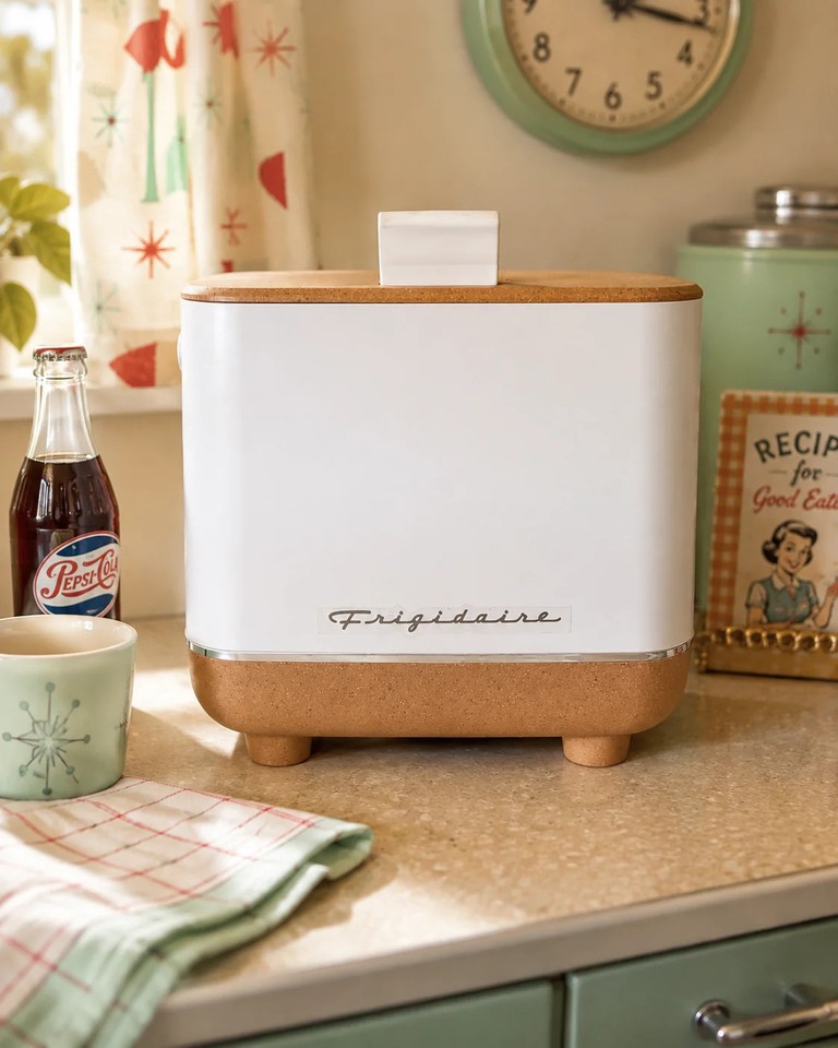 A genuinely retro-styled Frigidaire mini fridge in cream and tan — looks like it escaped from a 1950s kitchen and is perfect for a desk or dorm.