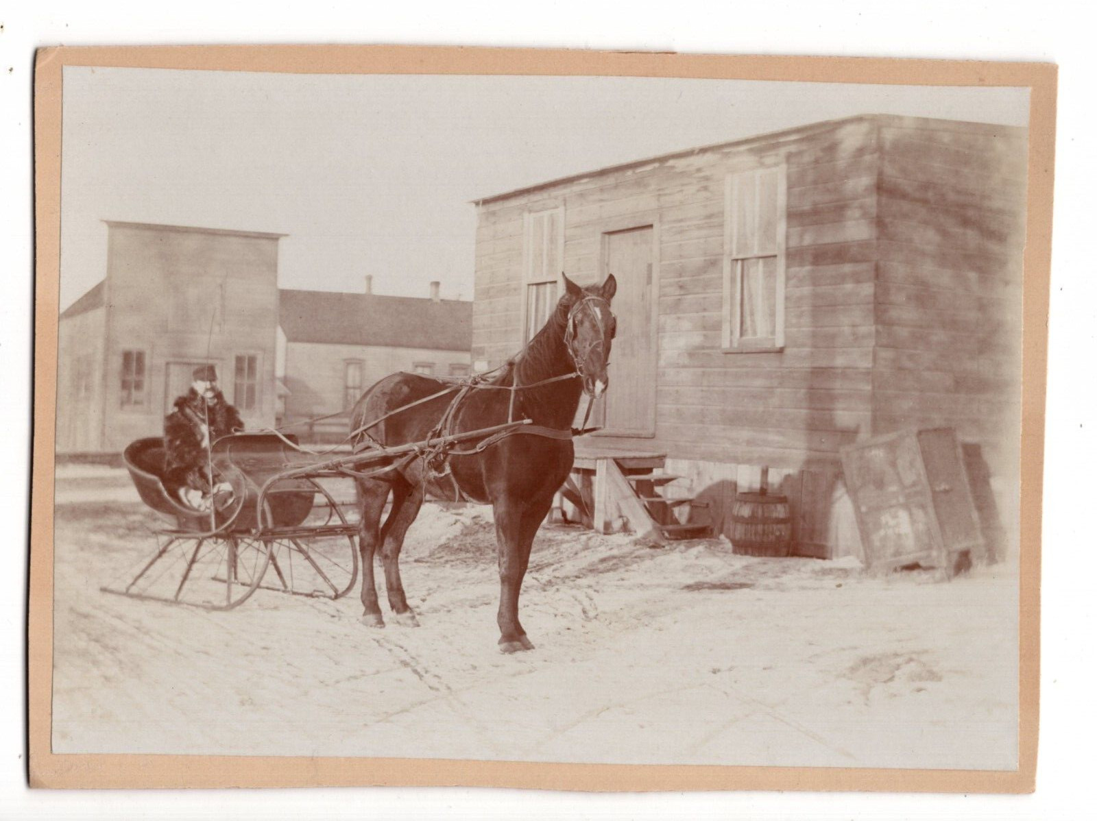 CIRCA 1900s CABINET CARD MAN ON HORSE-DRAWN SLED OUTSIDE OLD WEST SMALL TOWN