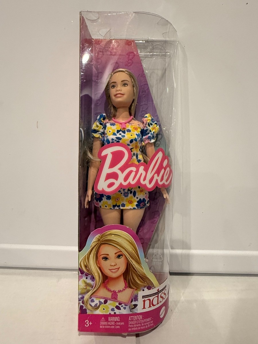barbie fashionistas doll with down syndrome wearing floral dress FIRST LOOK: Barbie unveils the first-ever doll with Down syndrome!, @mattel partnered with the National Down Syndrome Society for the addition to the #Barbie Fashionista line. , #BarbieDoll #Doll