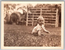Vtg B&W Snapshot Cute Baby Boy Sitting On Grass Lawn Yard Outdoor Trellis 1929