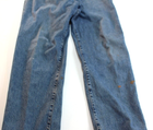 Blue VTG Lucky Brand jeans with 34x30 medium wash, brown paint splatter on left leg, and yellow stitched seam detail.