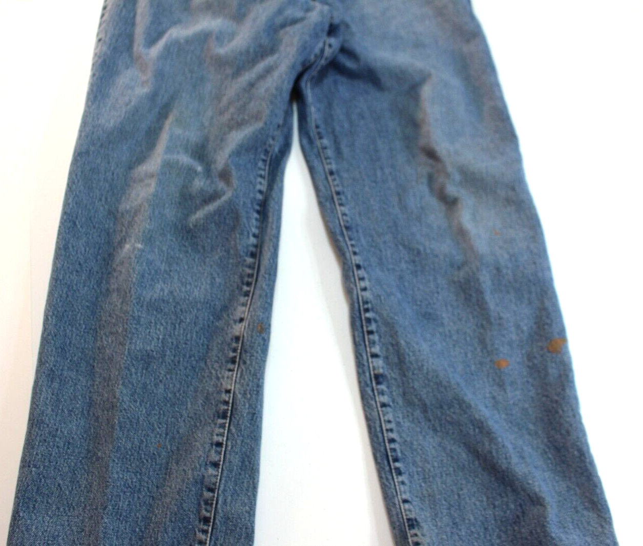 Blue VTG Lucky Brand jeans with 34x30 medium wash, brown paint splatter on left leg, and yellow stitched seam detail.