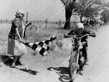 crp-50595 1970 Michael J Pollard on motorcycle, Lucille Benson waves checkered f