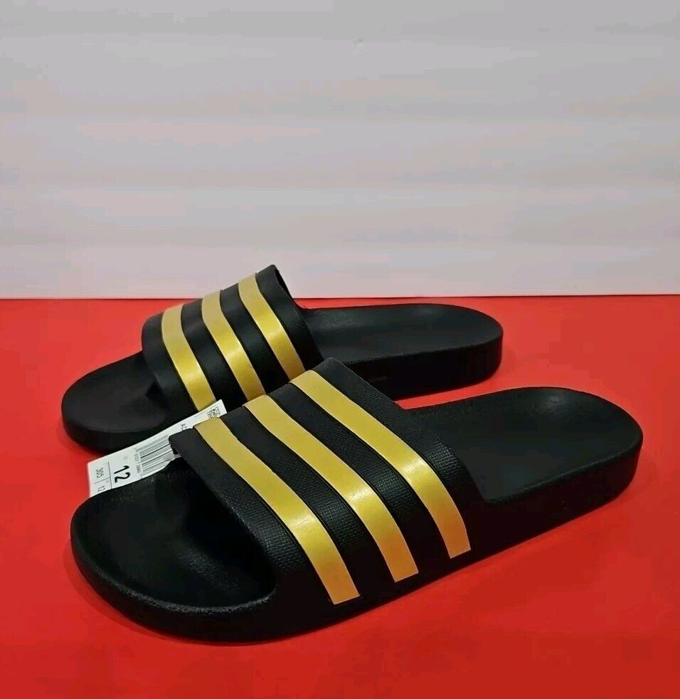 ◆adidas◆アディダス ADILETTE AQUA U EG1758 CORE/GOLD/CORE Adidas UNISEX ADILETTE Aqua Slides Pine Black Gold EG1758