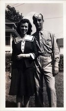 WW2 Photo of soldier with woman in yard smiling