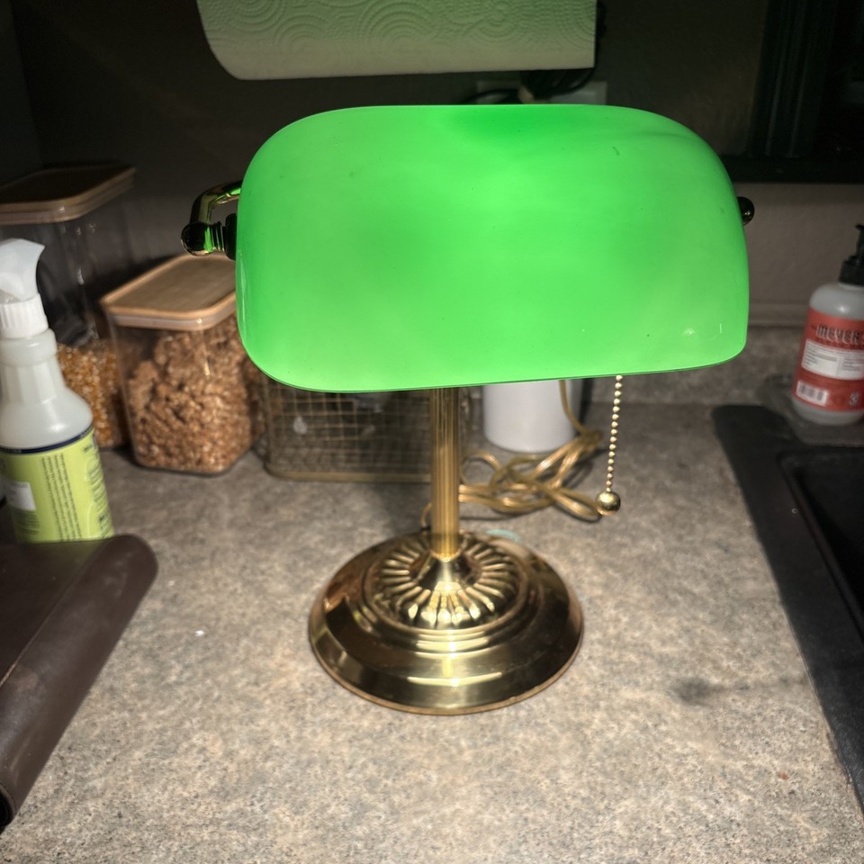 A classic green-glass bankers lamp with brass base in excellent condition — the timeless symbol of the serious, old-money desk that never goes out of style.