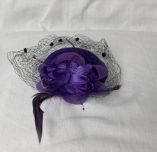 purple felt fascinator with a dotted fishnet veil, floral ribbon, lace  Feather