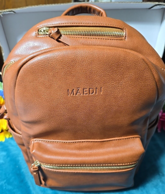 brown vegan leather backpack purse 22 Tote Sling  To The Nines Manitowish Waters BP1993 Convertible design 2 front zip pockets Back zip pocket 2 inner slip pockets 1 inner zip pocket Removable guitar strap Dimensions and Care 14L x 13H x 7D Crafted from high Brown Leather Laptop Backpack Womens