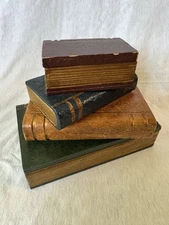 Vintage wooden boxes for decoration in the shape of books, two of them with lids