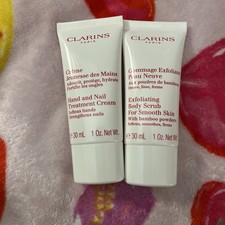 Clarins 1oz Hand And Nail Cream And Clarins 1oz Exfoliating Body Scrub