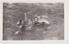 Two Dashing Young Men Swim Fearlessly Through the Open Sea Waves Men Shirtless