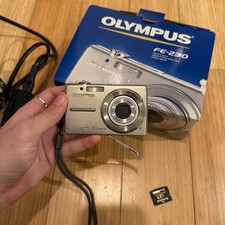 OLYMPUS CAMERA WITH PACKAGING AND XD CARD AND CHARGER