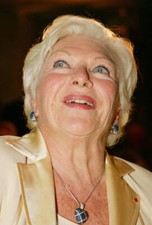 Legendary French entertainer Line Renaud listens to speakers at he - Old Photo