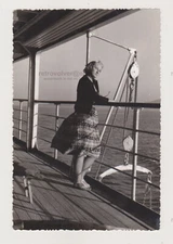 Beautiful Young Woman on Deck Lost in Contemplation Amidst the Sea's Embrace