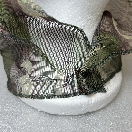 Close-up of Vtg Camo hunting mosquito net with green and brown camouflage pattern and textured mesh fabric.