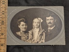 antique cabinet photo of golden hair girl and parents cut down