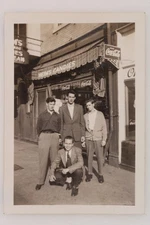 FOUND PHOTO Four Young Men Posing In Front Candy Store Street Snapshot Vtg 1940s